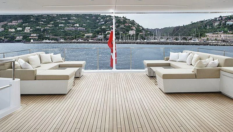 a deck with a large body of water and a large red flag aboard LAMMOUCHE Yacht for Sale