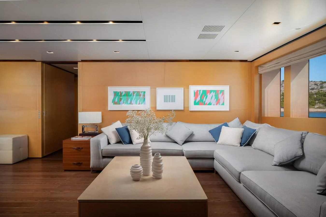 a living room with a couch and a coffee table aboard LAMMOUCHE Yacht for Sale