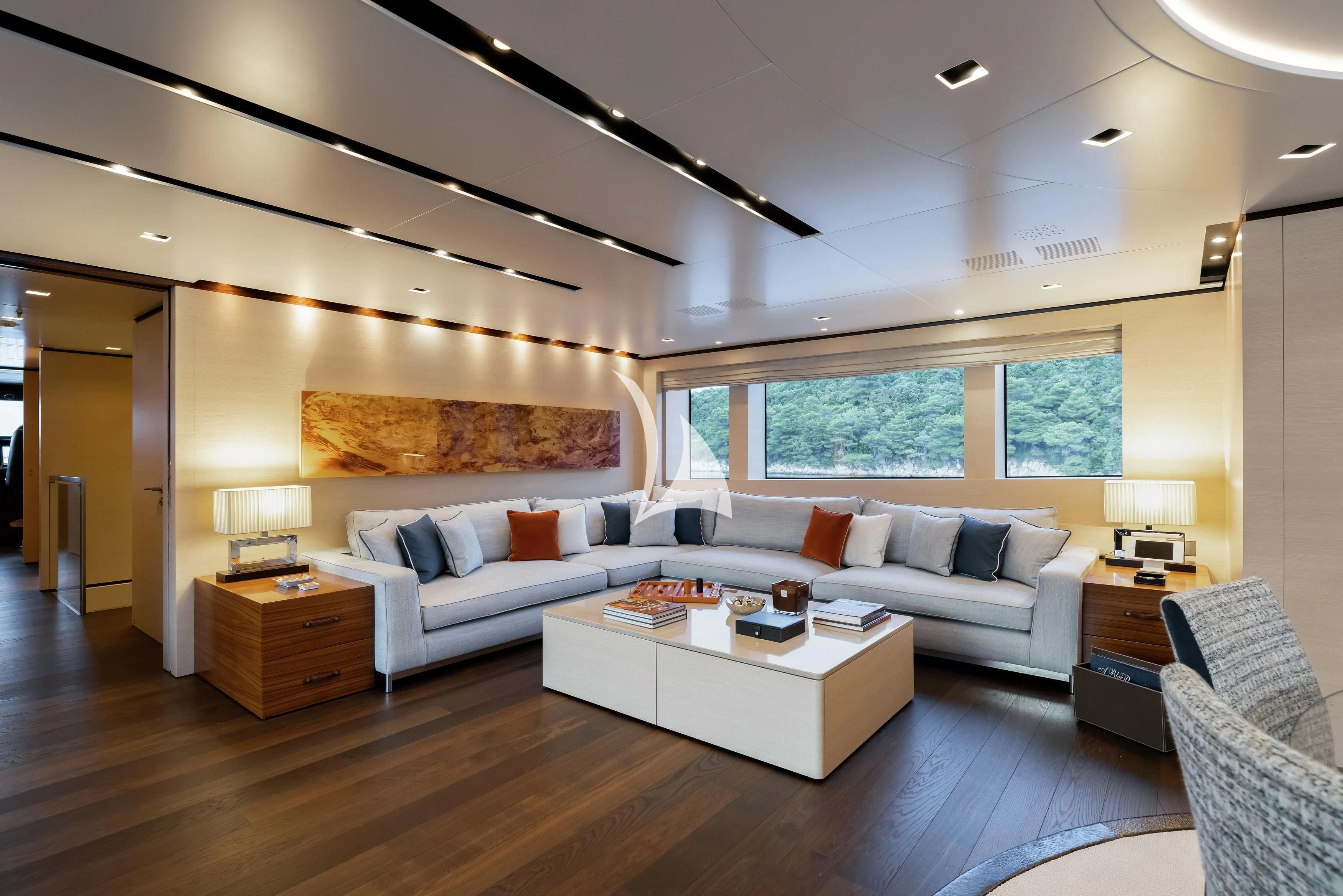 a living room with a couch and a table aboard LAMMOUCHE Yacht for Sale