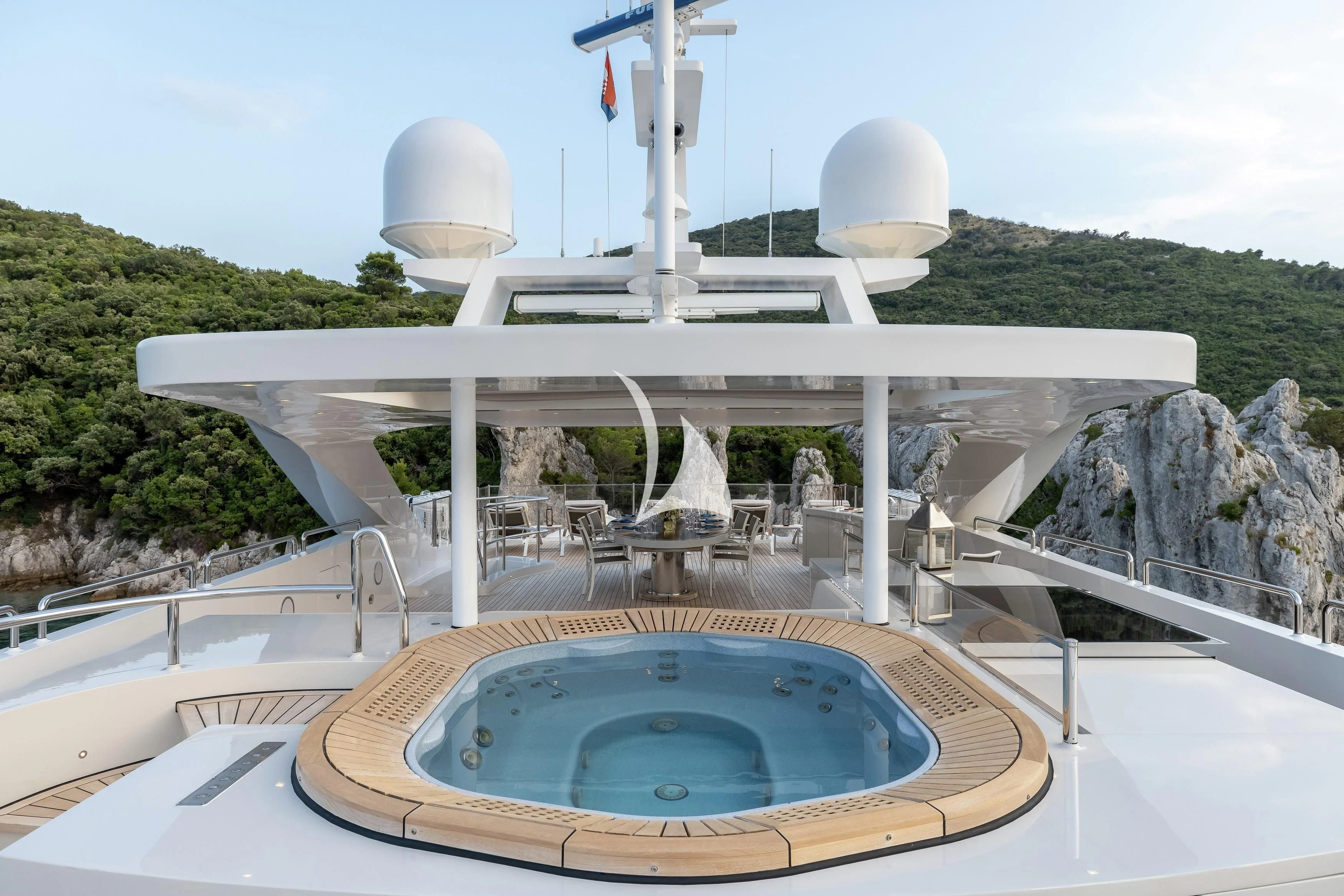 a swimming pool with a large white building and a dome on top aboard LAMMOUCHE Yacht for Sale