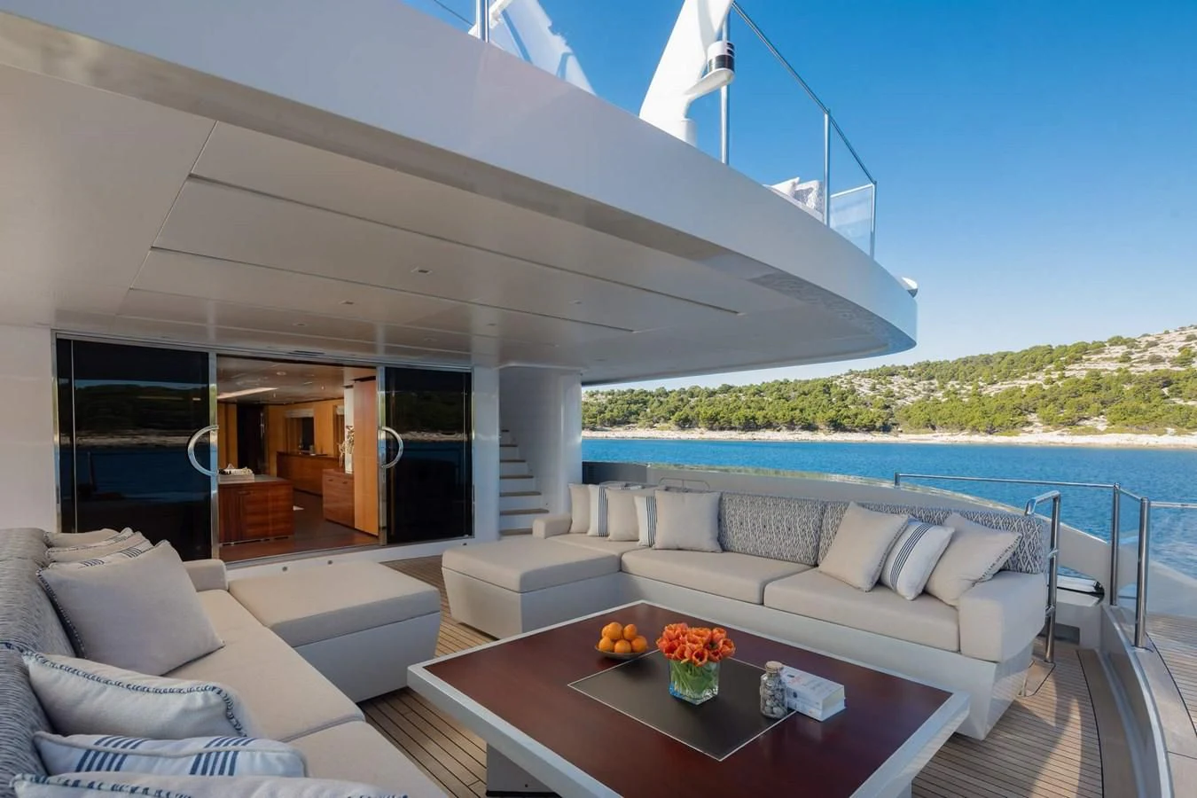 a living room with a large balcony aboard LAMMOUCHE Yacht for Sale