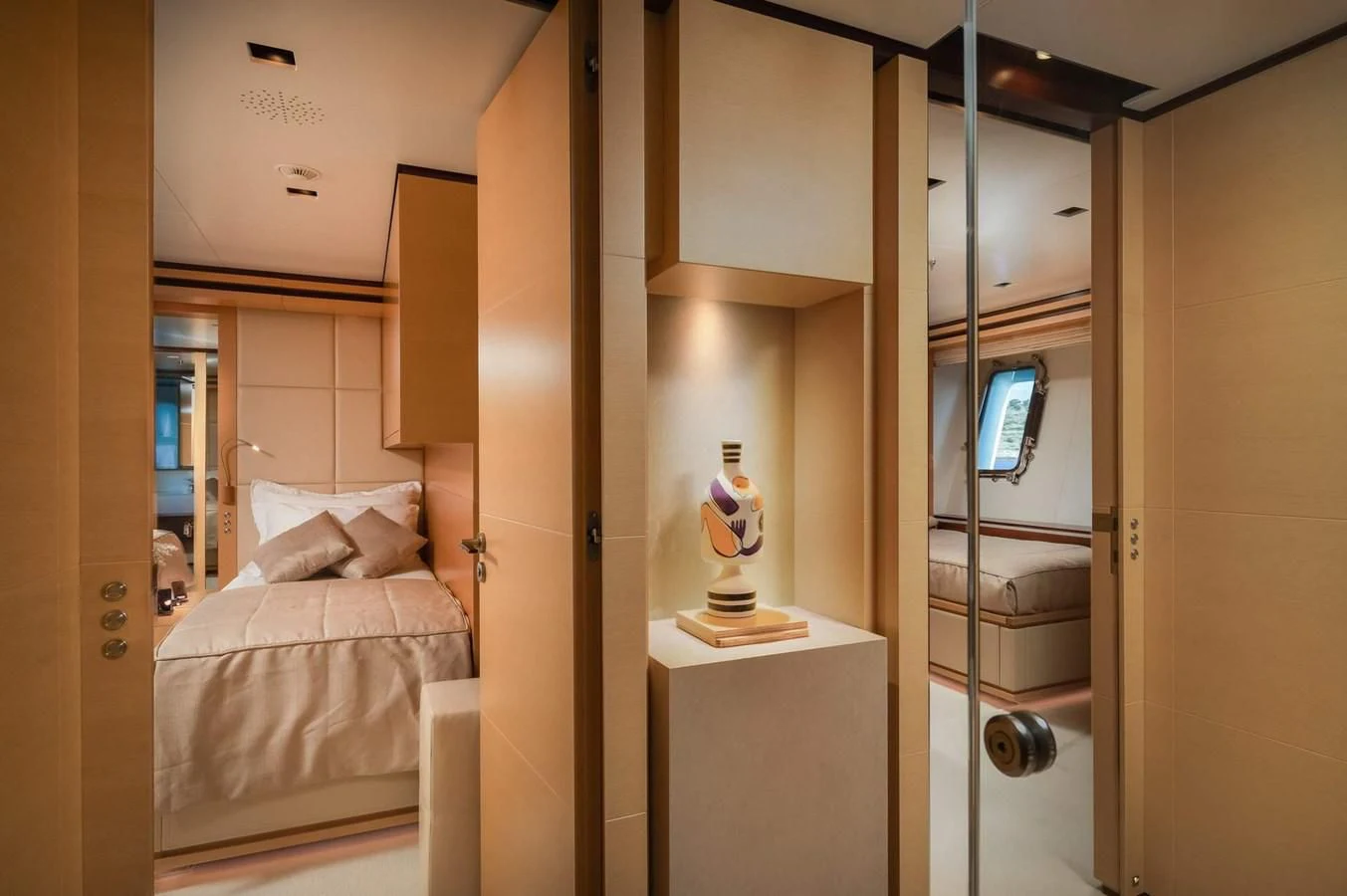 a bedroom with a glass door aboard LAMMOUCHE Yacht for Sale
