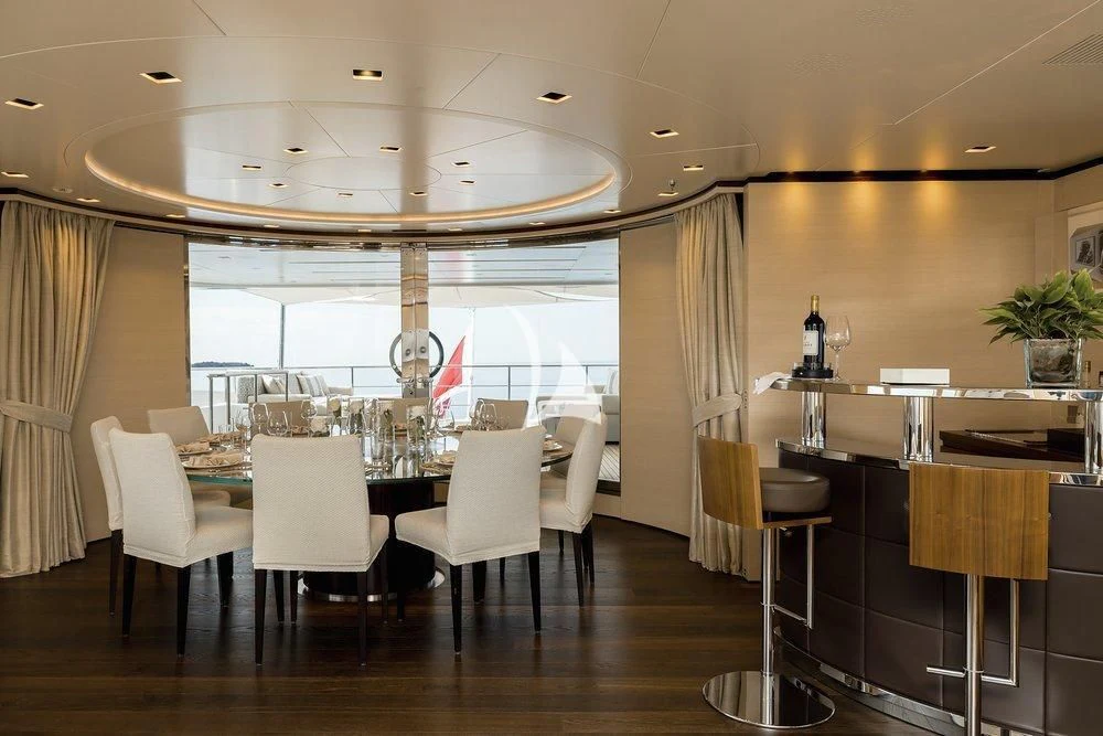 a room with a table chairs and a large window aboard LAMMOUCHE Yacht for Sale