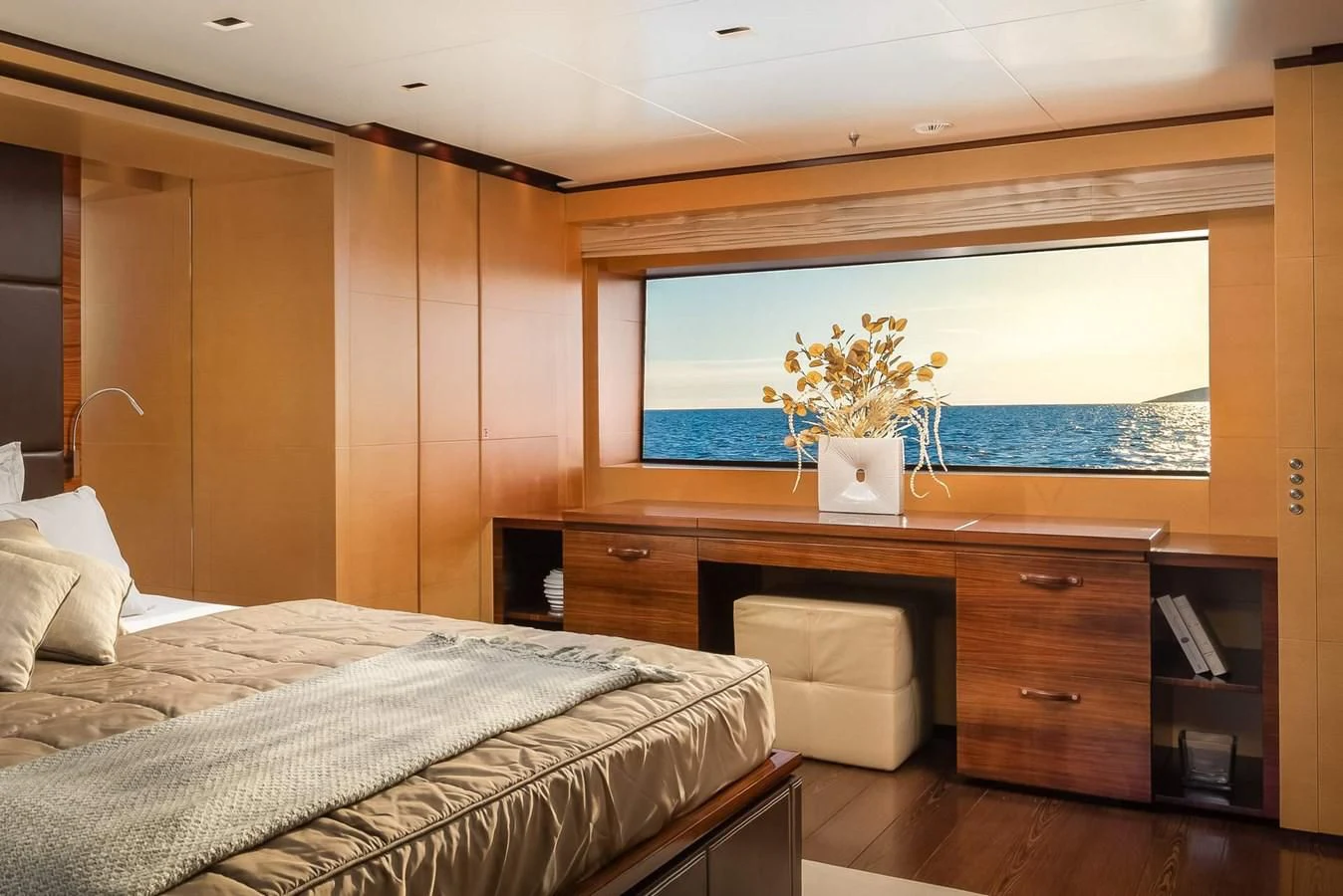 a bedroom with a bed and a desk aboard LAMMOUCHE Yacht for Sale