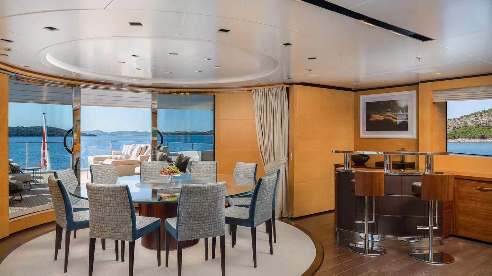 a room with tables and chairs aboard LAMMOUCHE Yacht for Sale