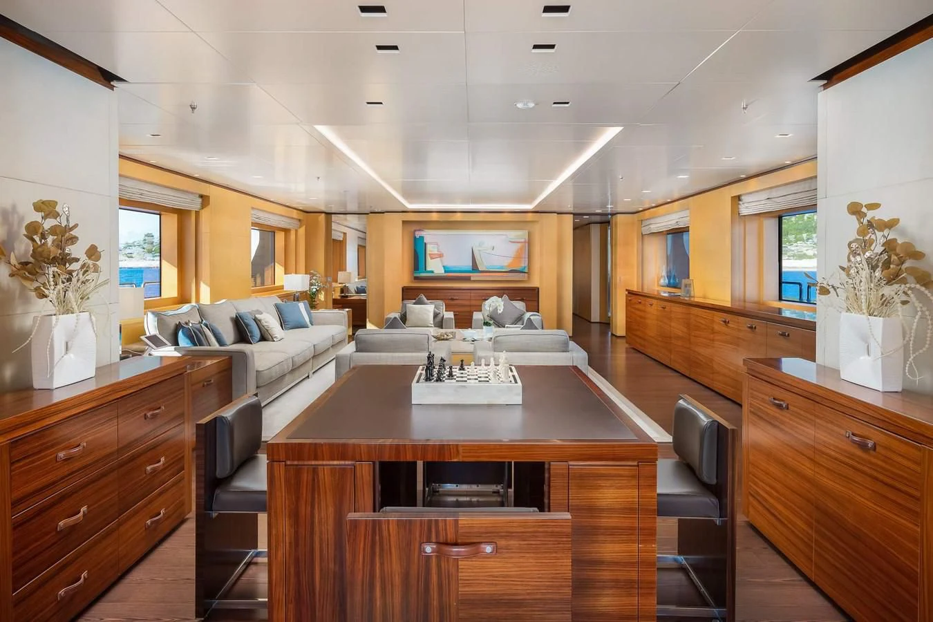 a living room with a table and chairs aboard LAMMOUCHE Yacht for Sale
