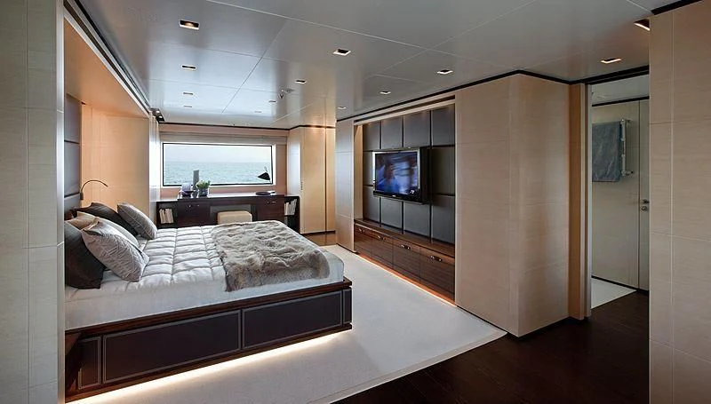 a bedroom with a bed and a tv aboard LAMMOUCHE Yacht for Sale