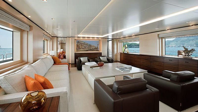 a living room with leather couches and a coffee table aboard LAMMOUCHE Yacht for Sale