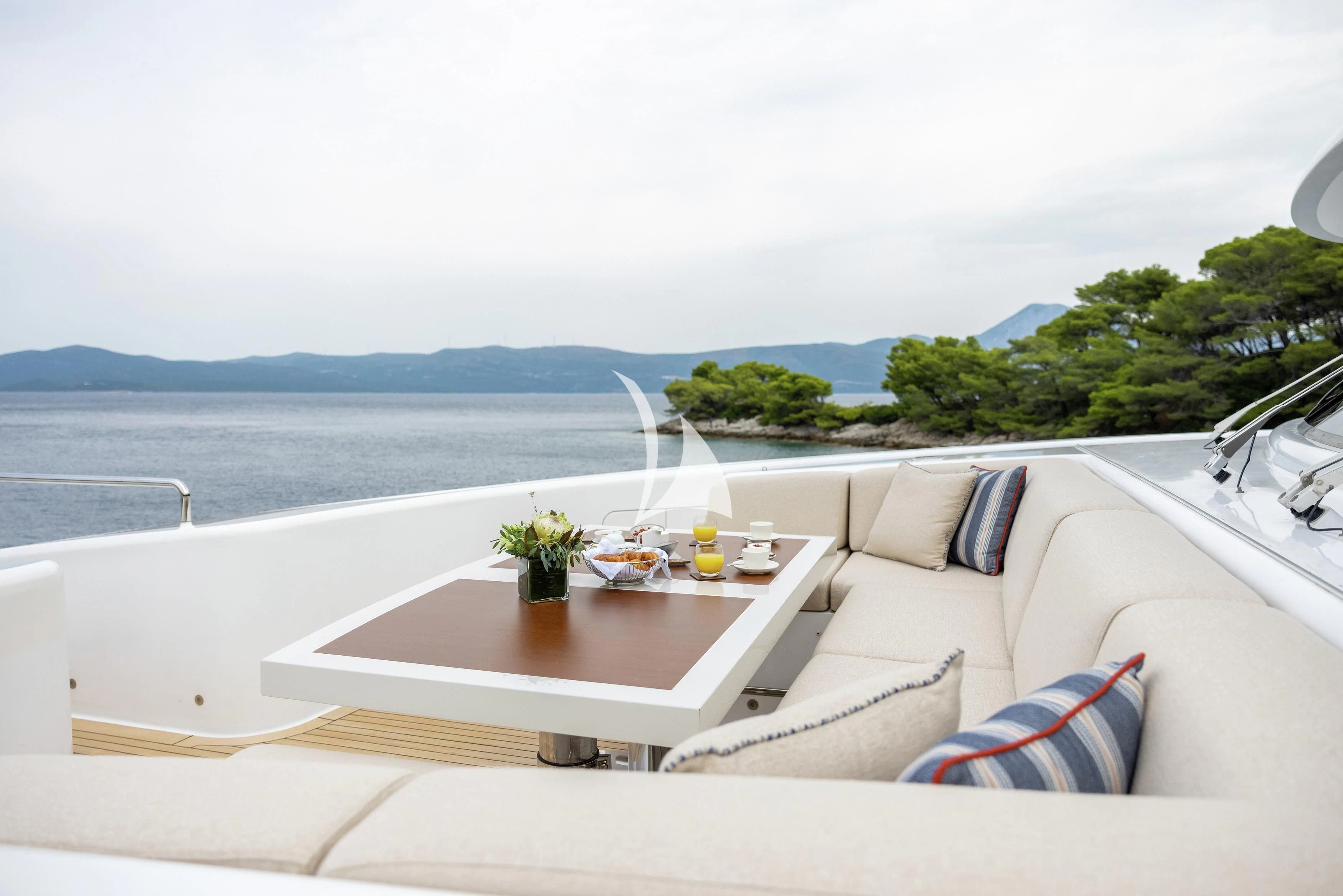 a table on a couch aboard LAMMOUCHE Yacht for Sale