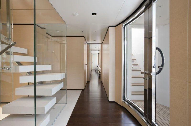 a hallway with glass doors aboard LAMMOUCHE Yacht for Sale