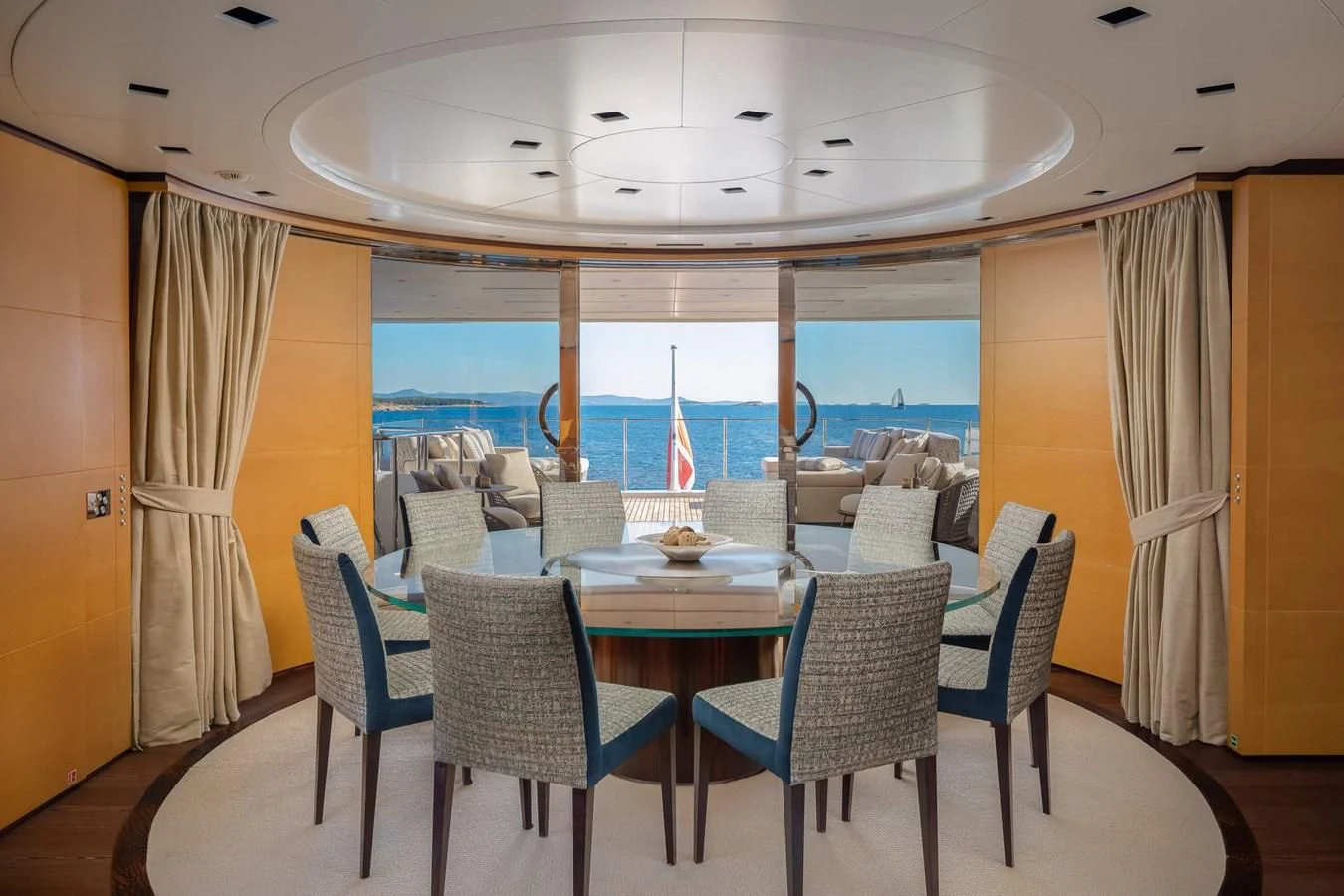 a room with a table and chairs aboard LAMMOUCHE Yacht for Sale