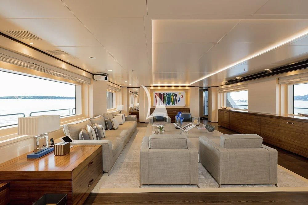 a living room with a couch and a table aboard LAMMOUCHE Yacht for Sale