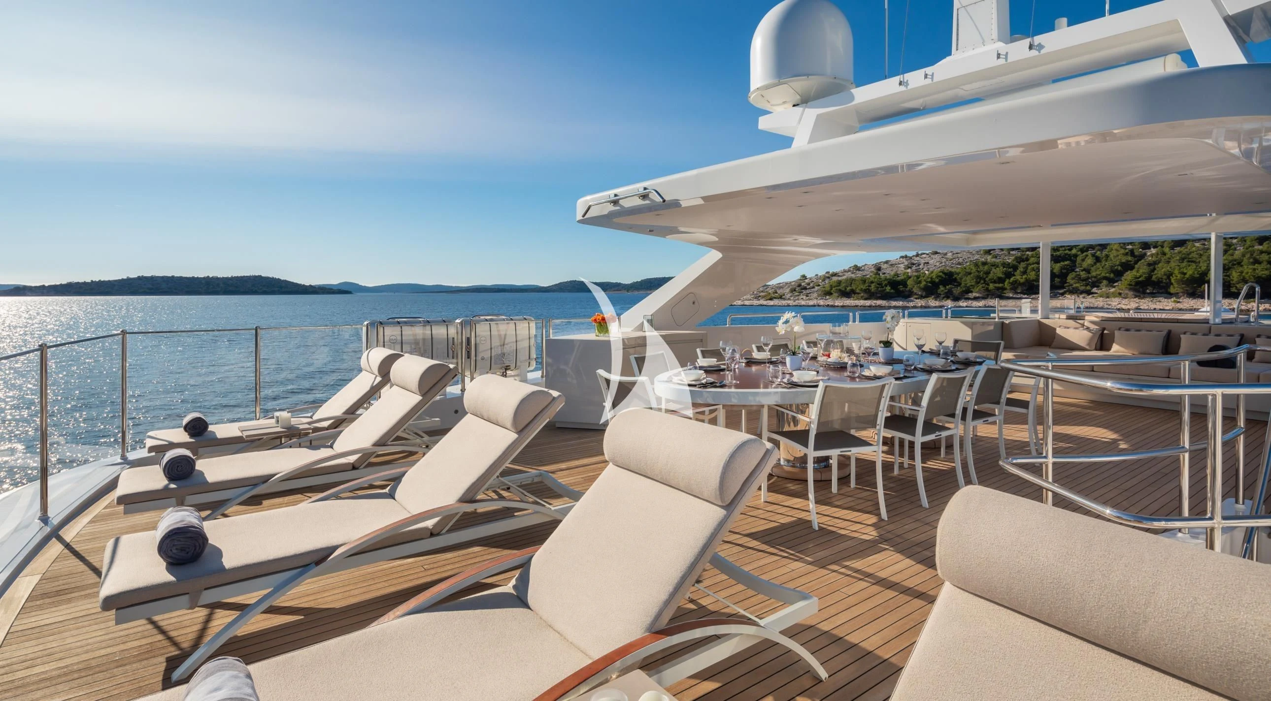a deck with chairs and a pool aboard LAMMOUCHE Yacht for Sale