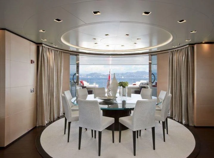 a room with a table and chairs aboard LAMMOUCHE Yacht for Sale