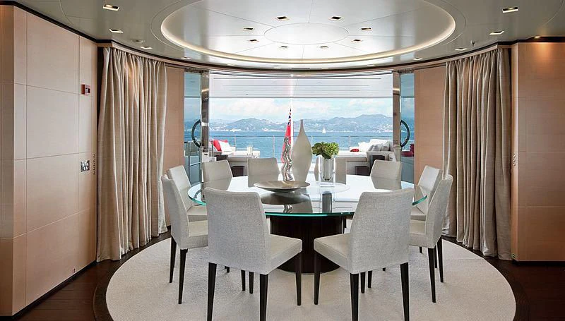 a room with a table and chairs aboard LAMMOUCHE Yacht for Sale