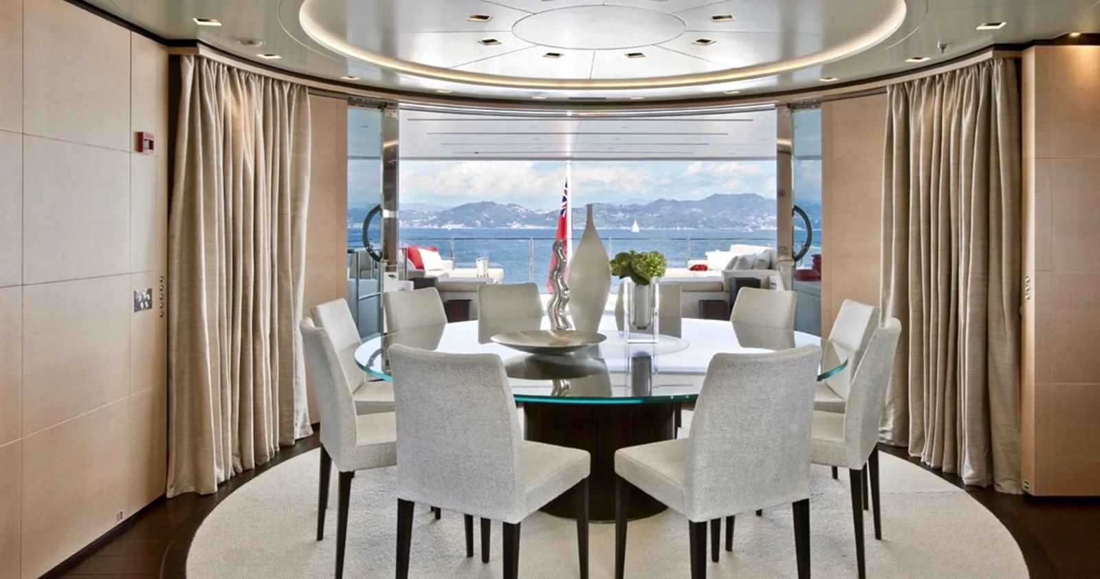 a room with a table and chairs aboard LAMMOUCHE Yacht for Sale