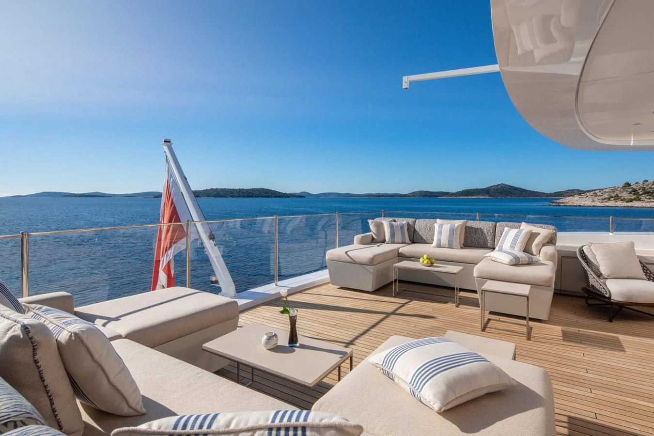 a lounge area with a large white sofa and a large sailboat on it aboard LAMMOUCHE Yacht for Sale