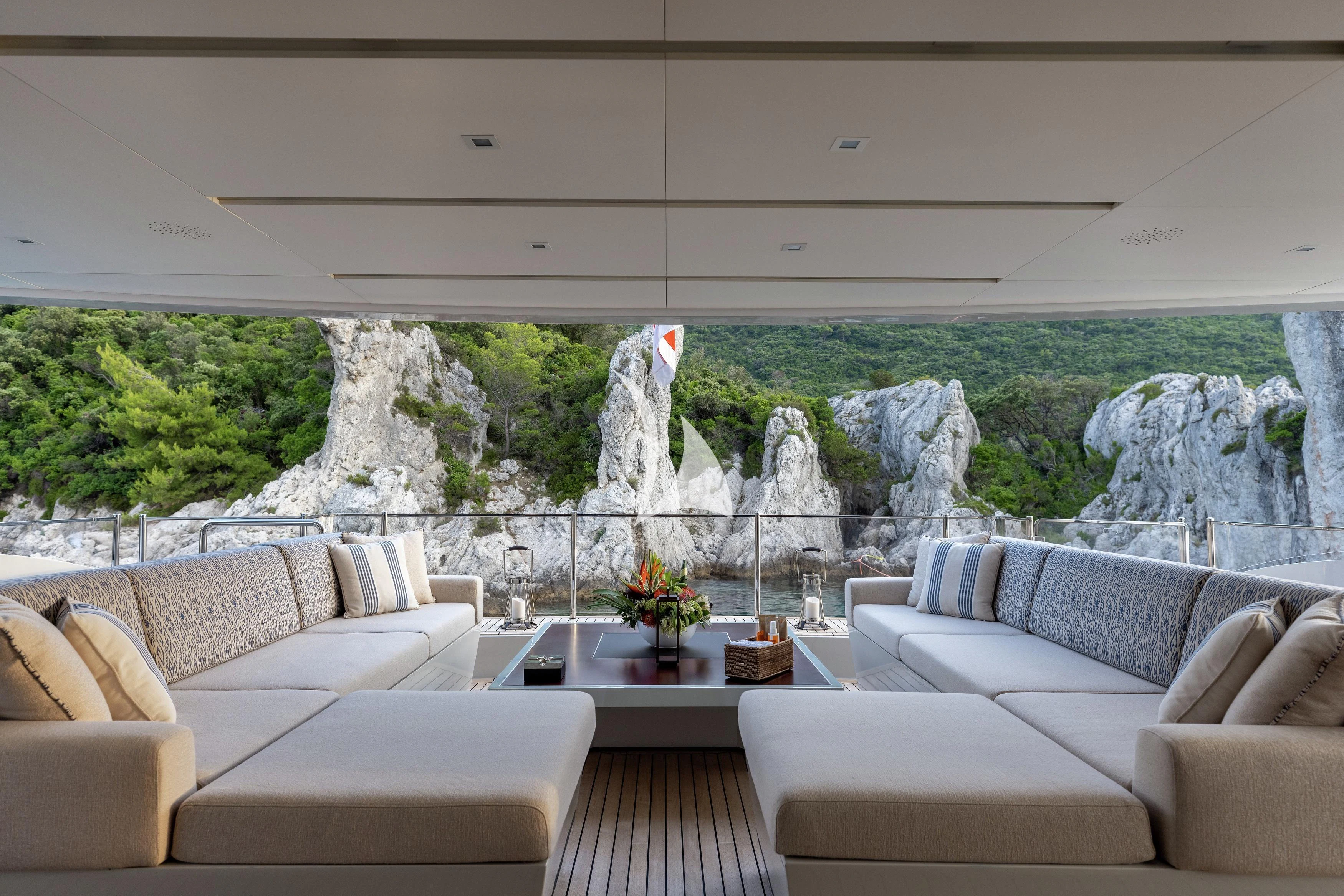 a living room with a large rock wall aboard LAMMOUCHE Yacht for Sale