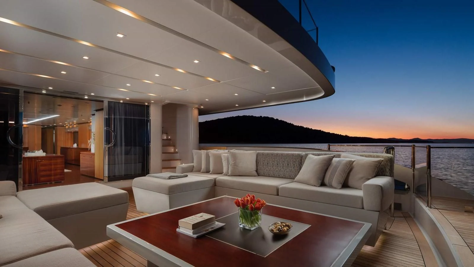 a living room with a large balcony aboard LAMMOUCHE Yacht for Sale