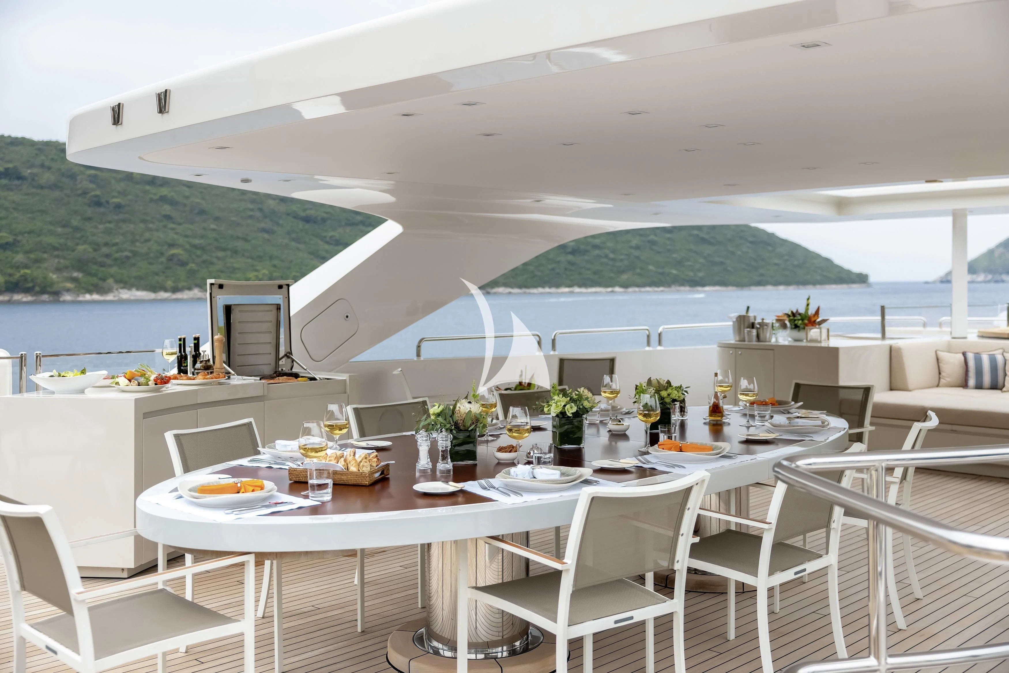a room with tables and chairs aboard LAMMOUCHE Yacht for Sale