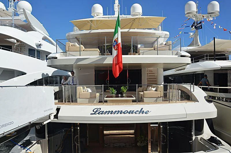 a boat with a flag on the front aboard LAMMOUCHE Yacht for Sale