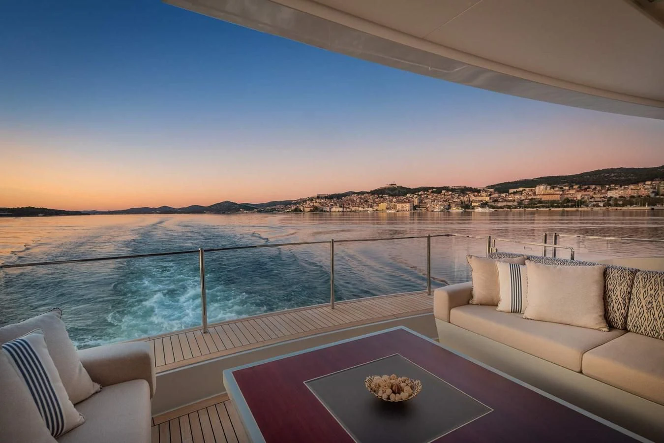a pool with a table and chairs by it aboard LAMMOUCHE Yacht for Sale