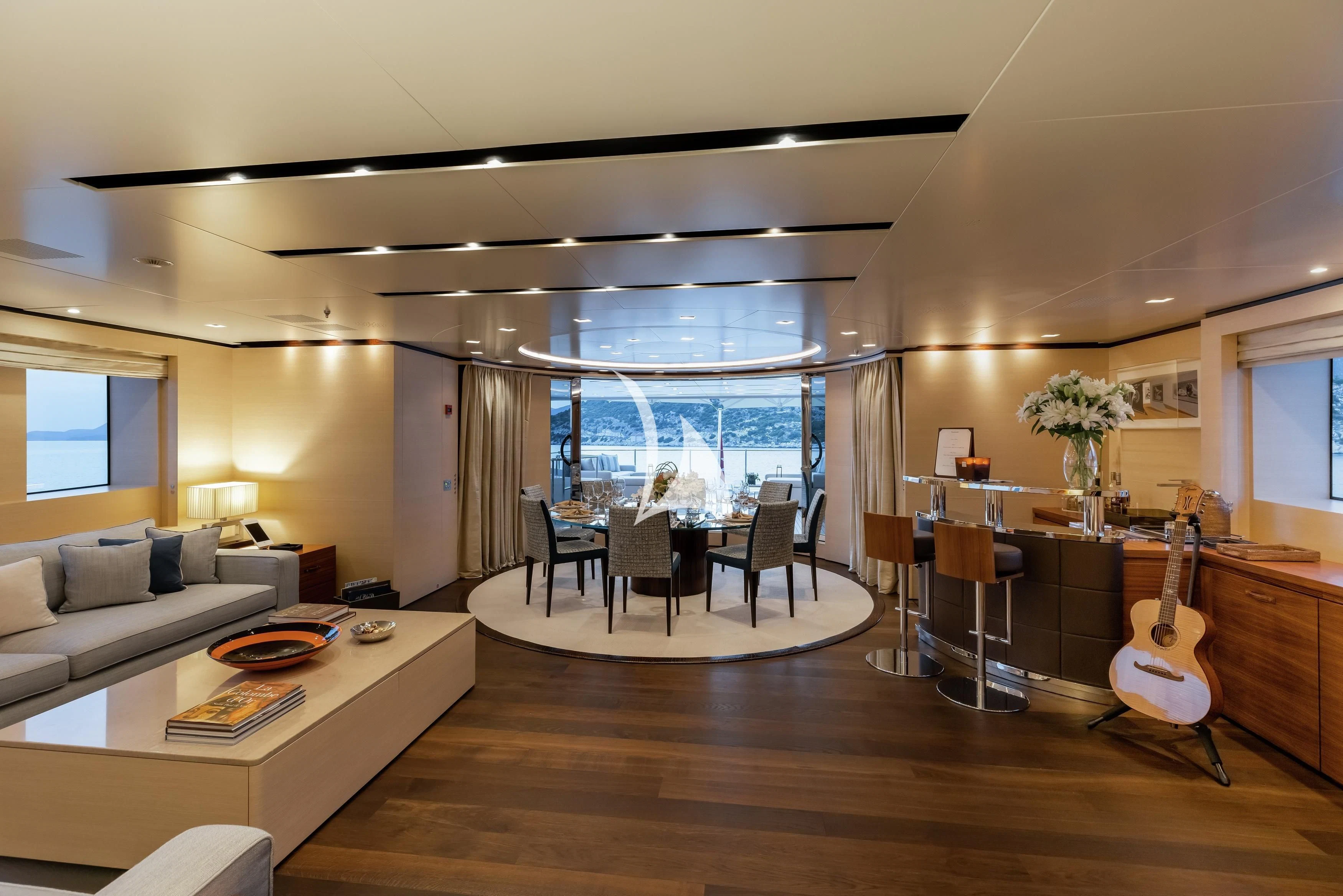 a living room with a piano and a piano aboard LAMMOUCHE Yacht for Sale