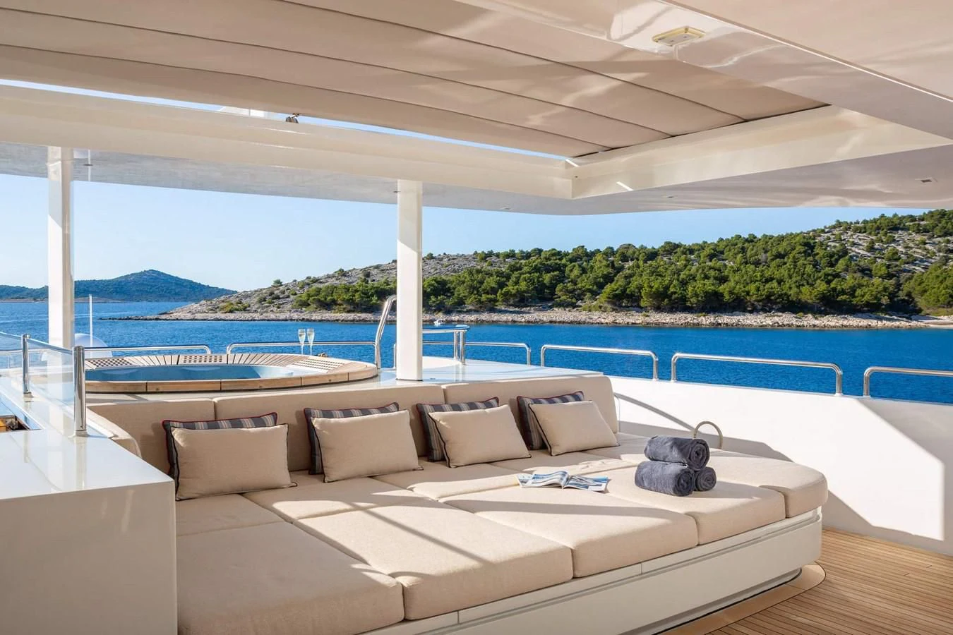 a large lounge chair next to a pool aboard LAMMOUCHE Yacht for Sale