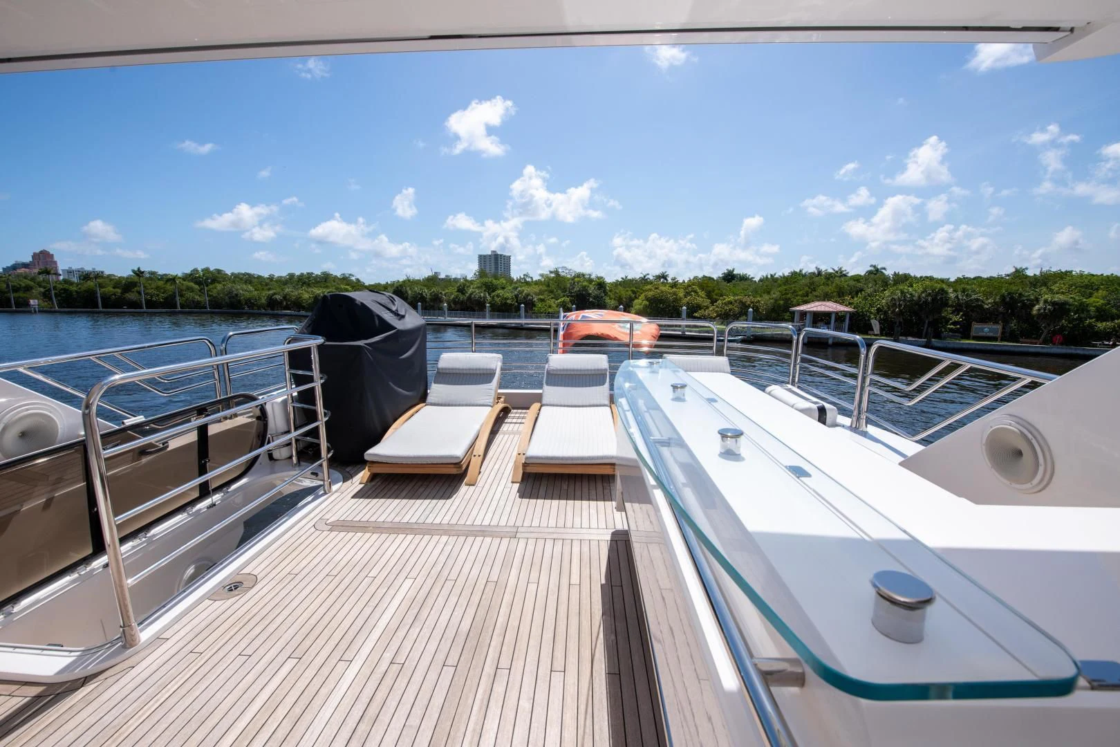 a deck with a view of a city and a body of water aboard FUNSEEKER Yacht for Sale