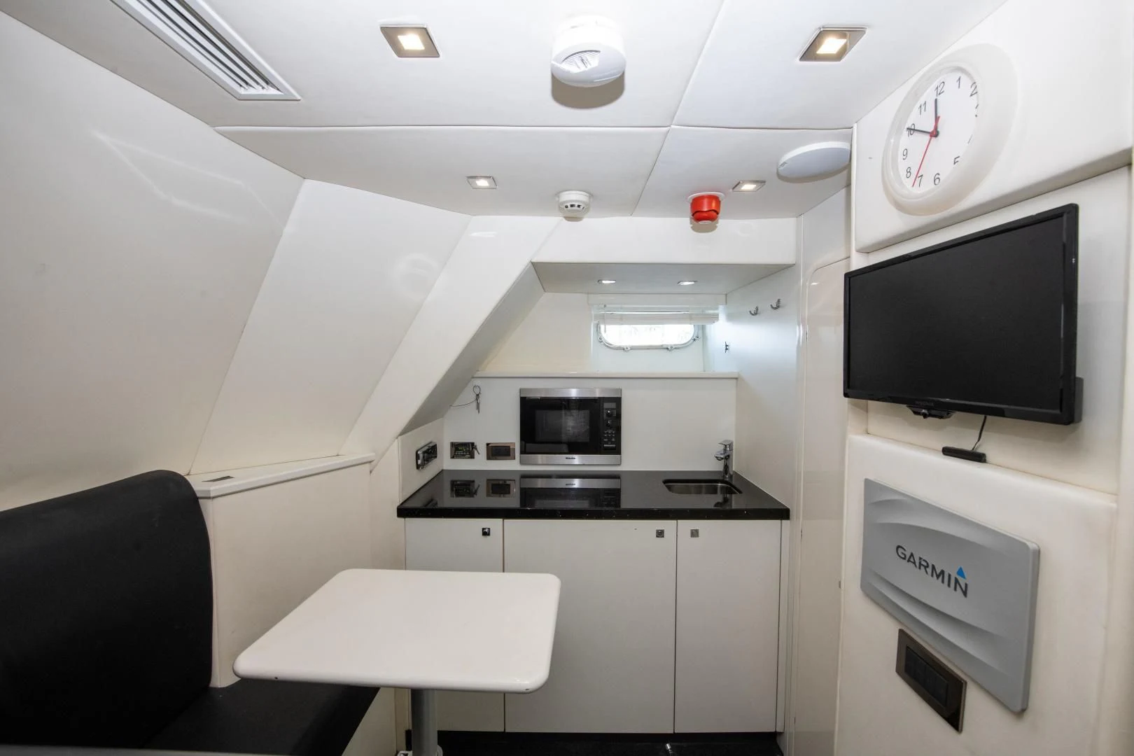 a small kitchen with a tv aboard FUNSEEKER Yacht for Sale