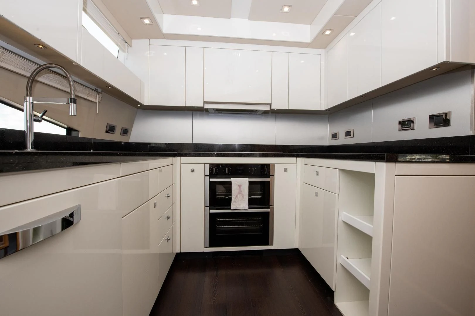 a kitchen with white cabinets aboard FUNSEEKER Yacht for Sale