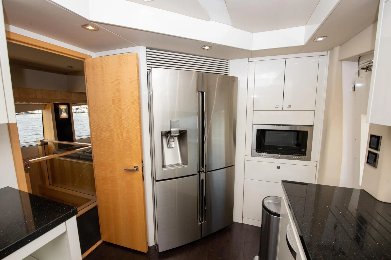 a kitchen with a refrigerator and microwave aboard FUNSEEKER Yacht for Sale