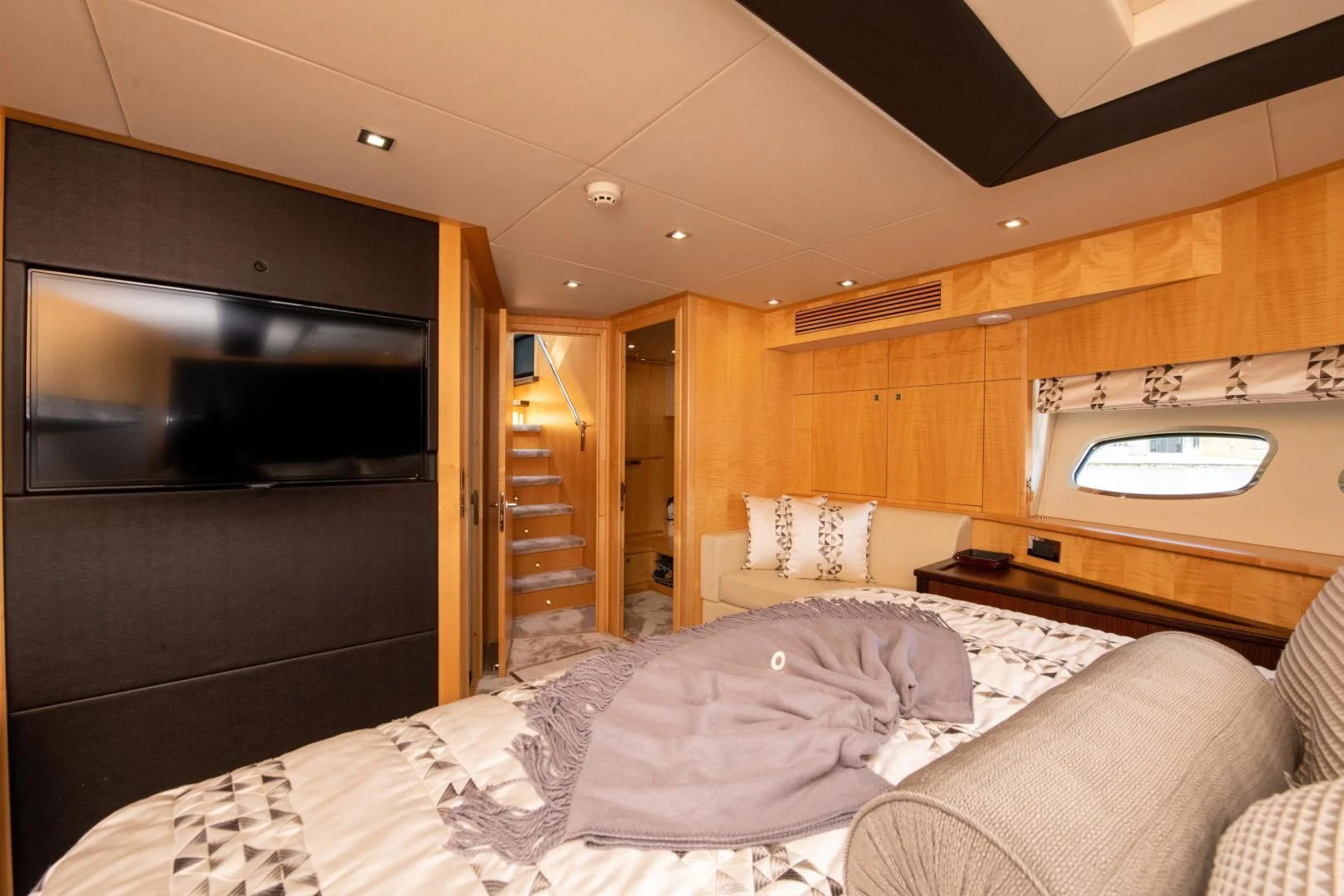 a bedroom with a bed and a tv aboard FUNSEEKER Yacht for Sale