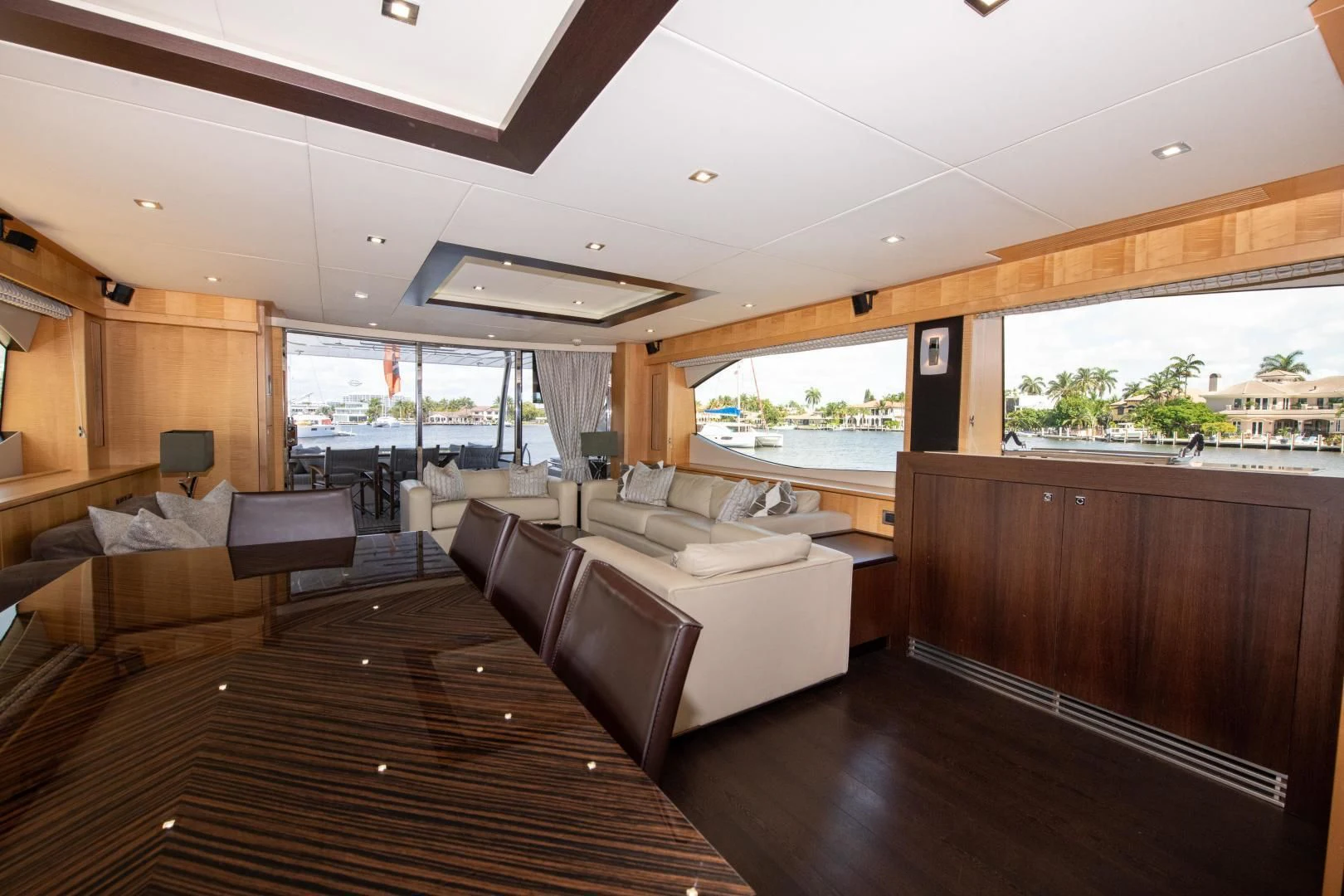 a living room with a wood floor aboard FUNSEEKER Yacht for Sale