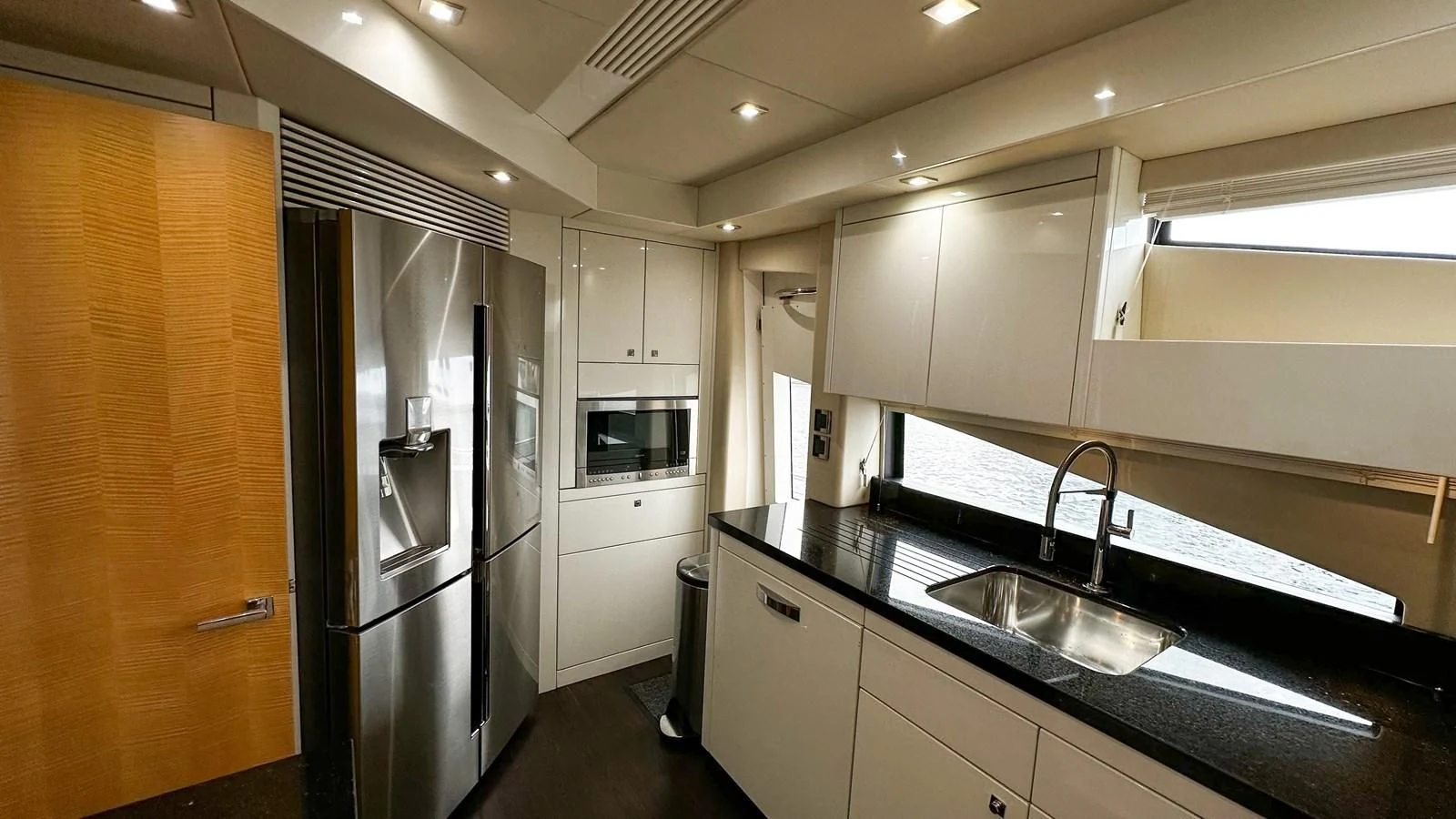 a kitchen with a refrigerator and sink aboard FUNSEEKER Yacht for Sale