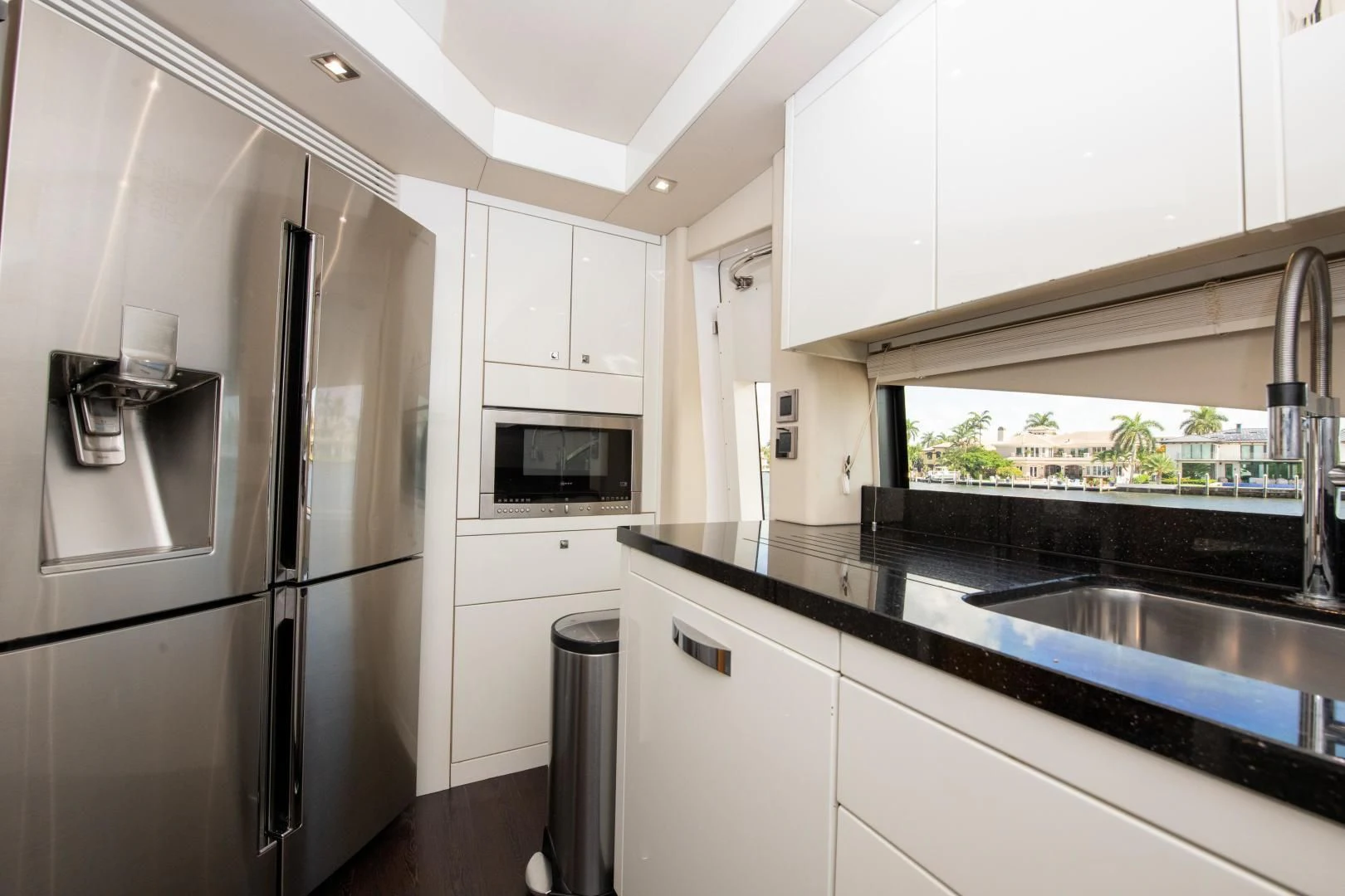 a kitchen with a refrigerator and microwave aboard FUNSEEKER Yacht for Sale