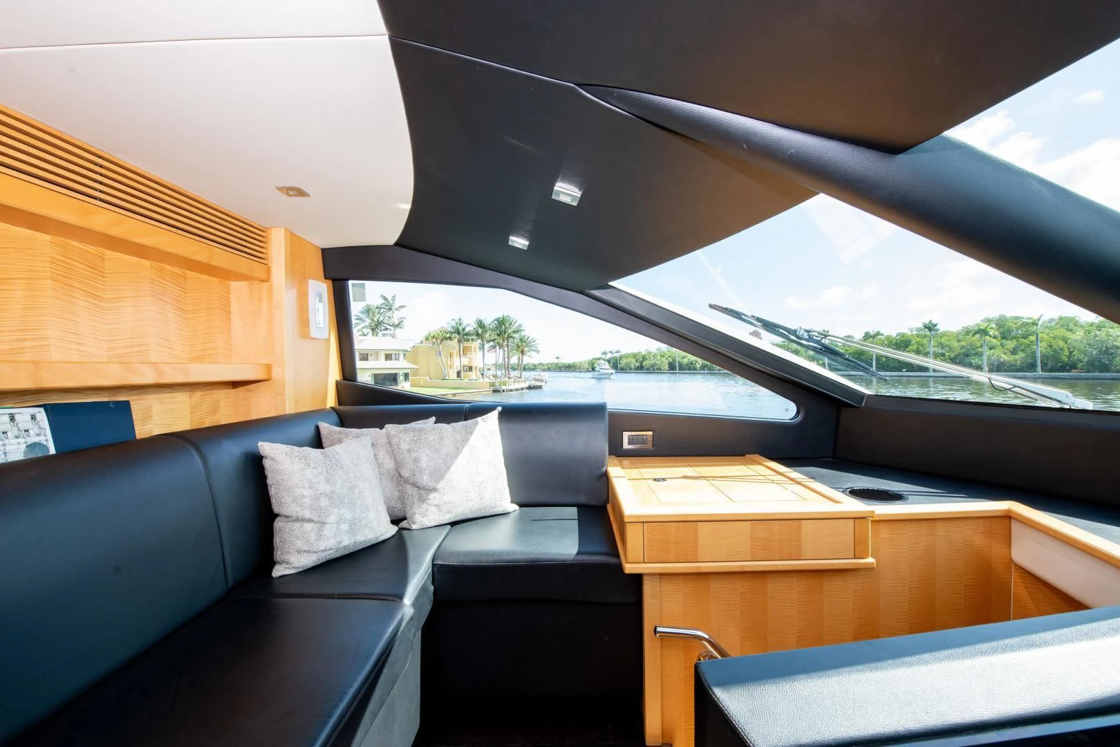 a room with a couch and a table with a bench aboard FUNSEEKER Yacht for Sale