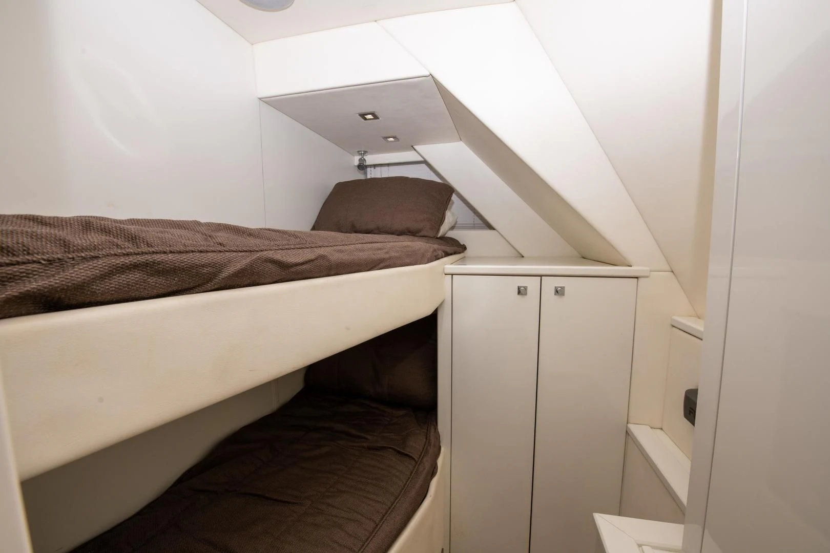 a bed with white sheets aboard FUNSEEKER Yacht for Sale