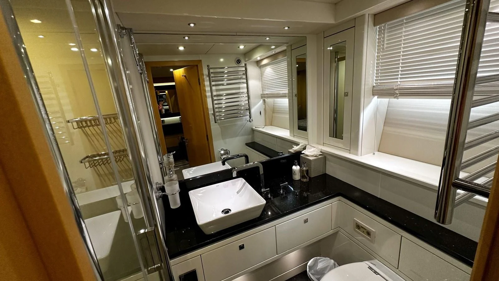 a bathroom with a large mirror aboard FUNSEEKER Yacht for Sale