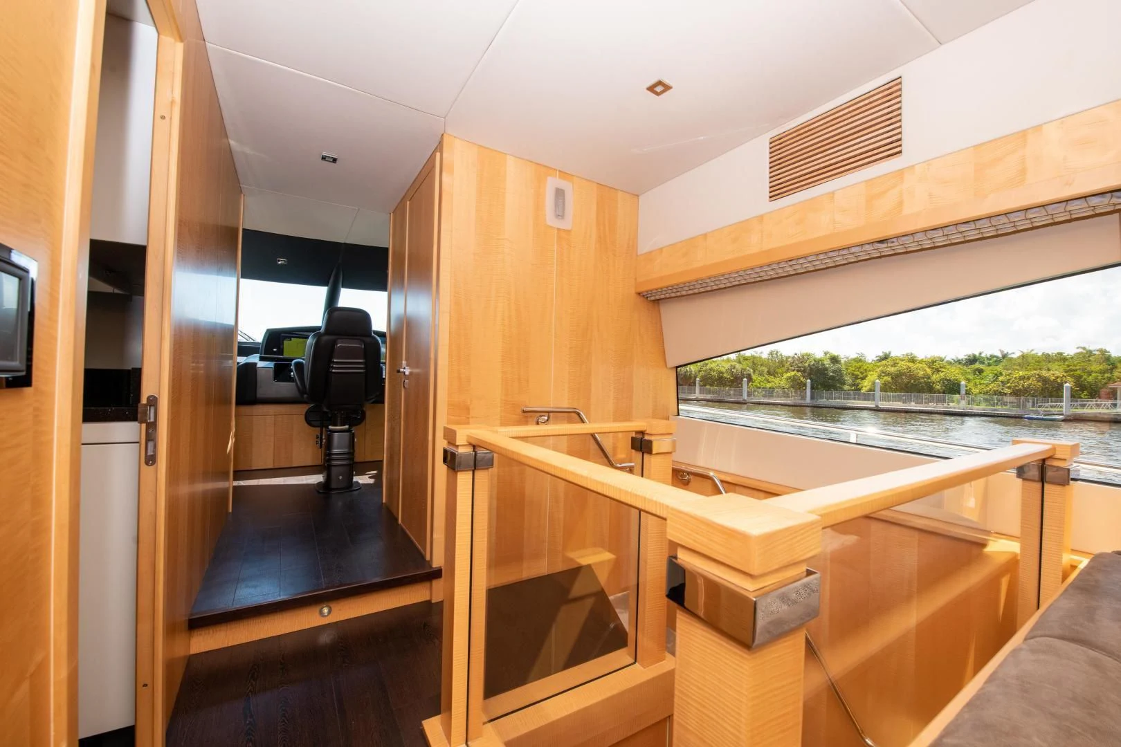 a room with a deck and a view of the water aboard FUNSEEKER Yacht for Sale