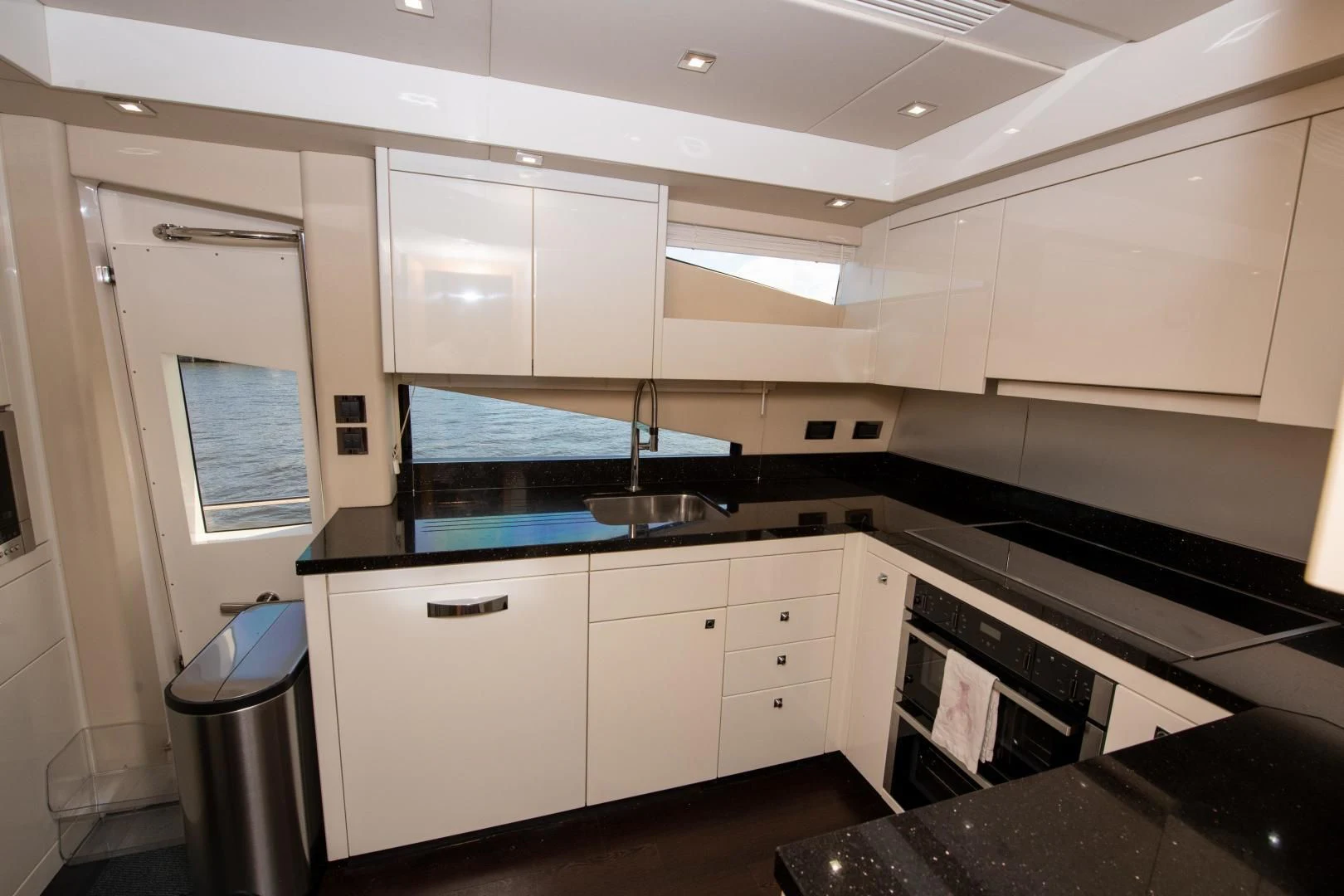 a kitchen with white cabinets aboard FUNSEEKER Yacht for Sale