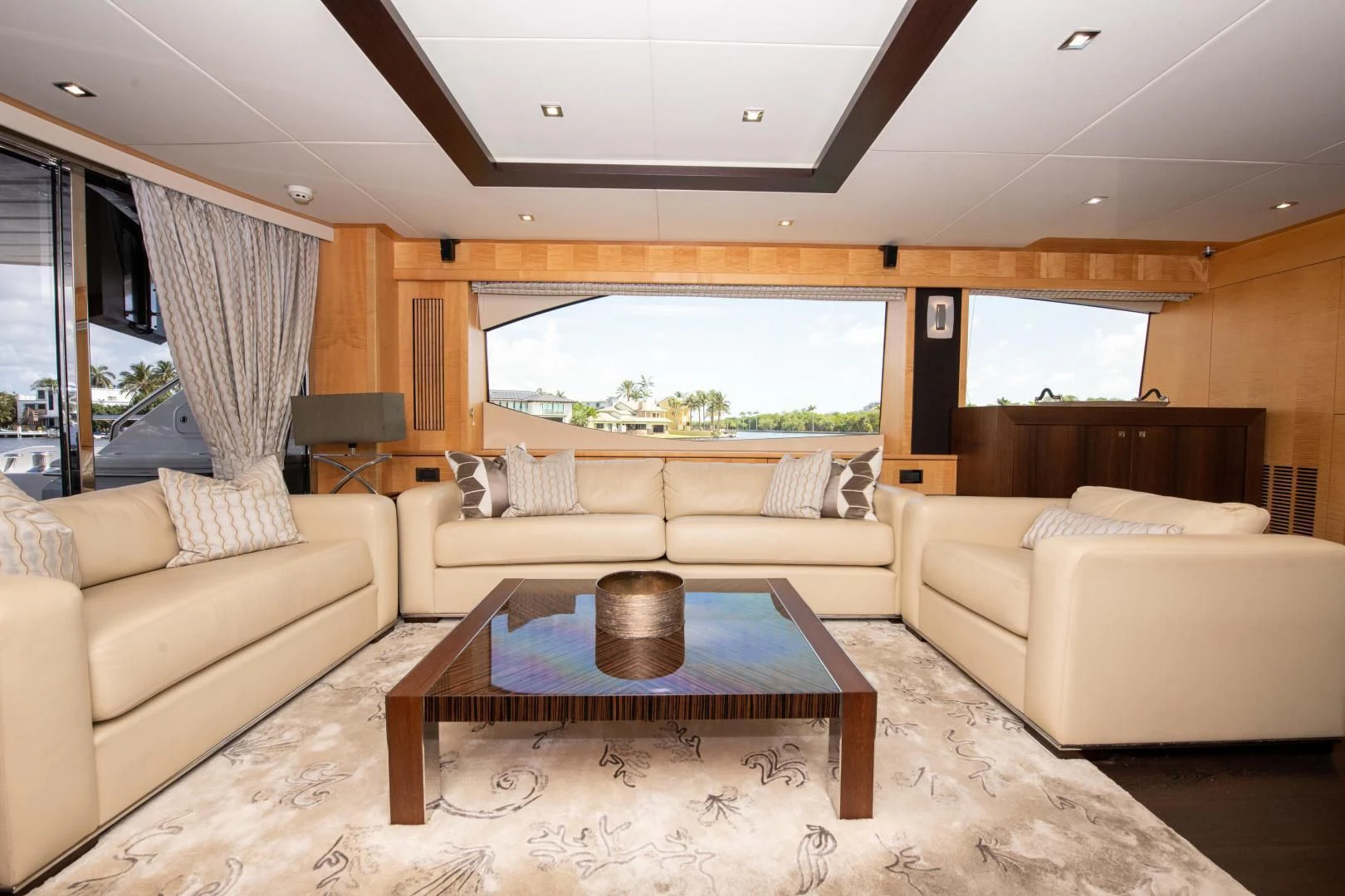 a living room with a table and a glass window aboard FUNSEEKER Yacht for Sale