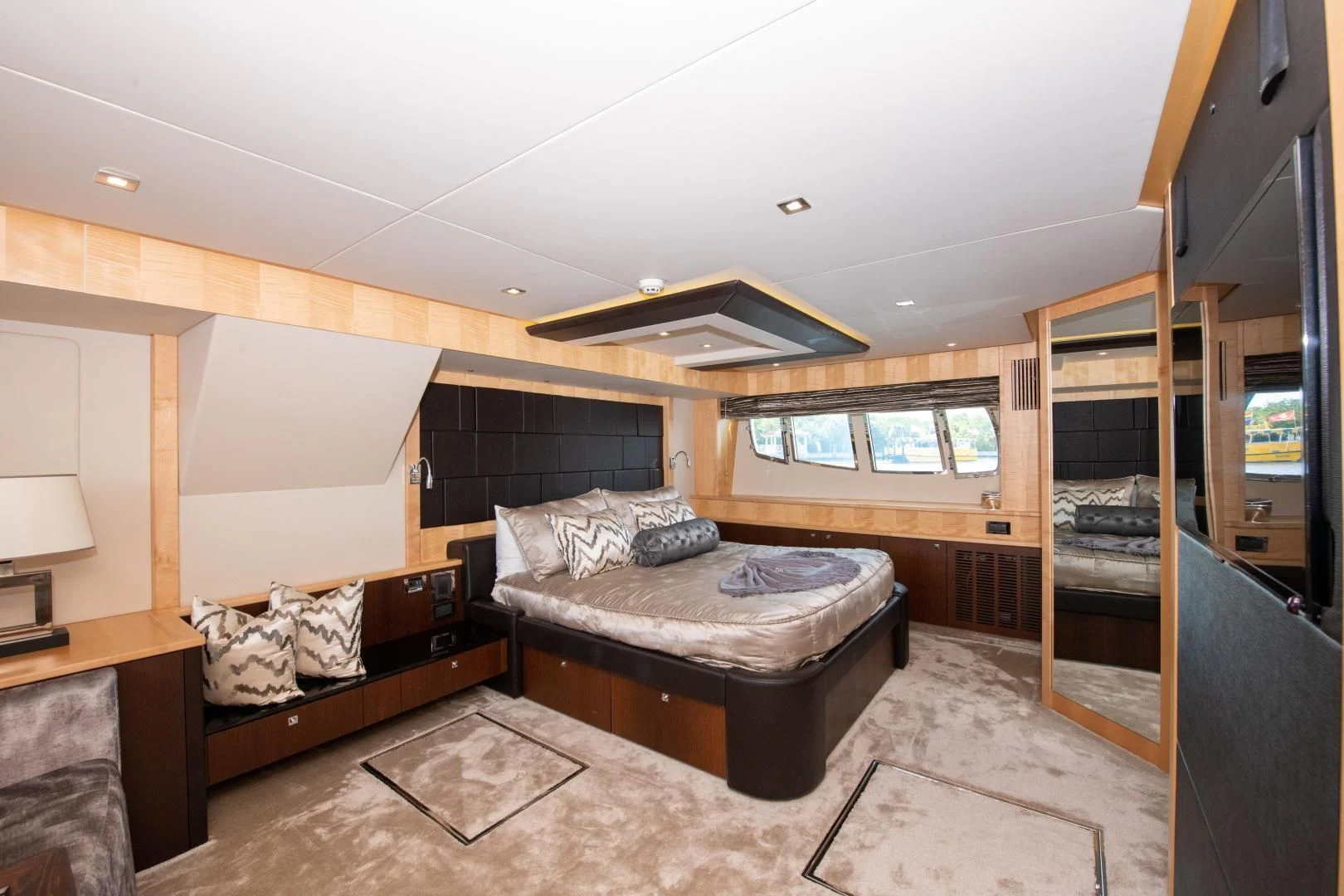 a bedroom with a bed and a desk aboard FUNSEEKER Yacht for Sale