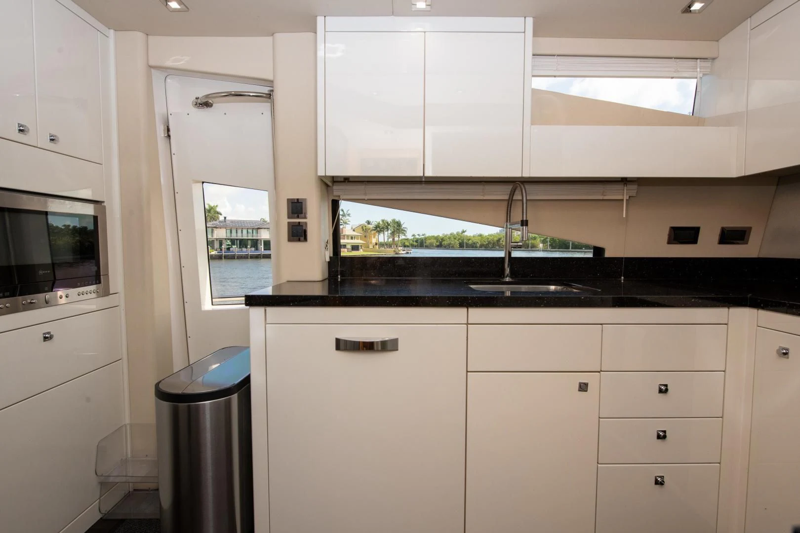 a kitchen with white cabinets aboard FUNSEEKER Yacht for Sale