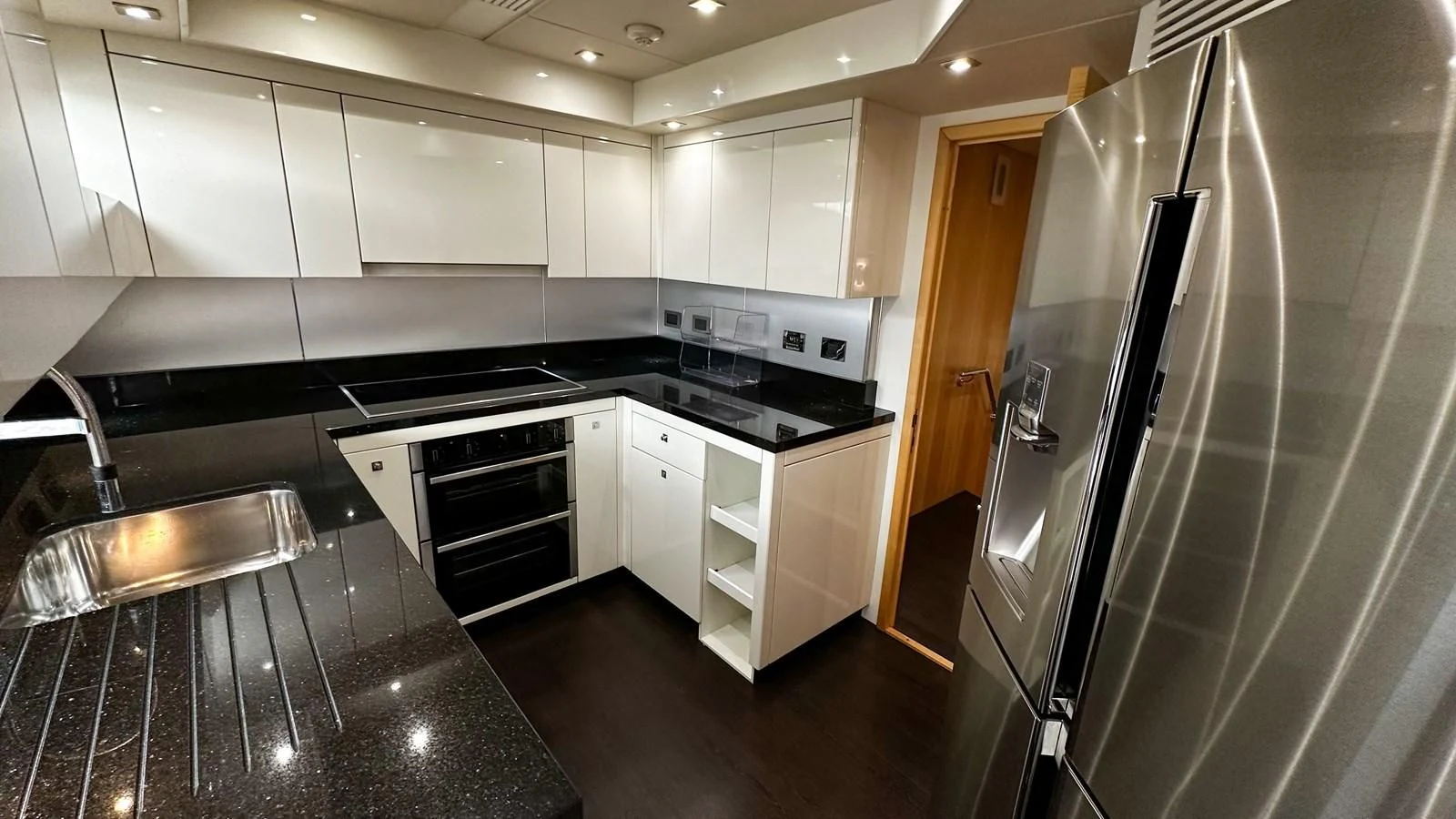 a kitchen with white cabinets aboard FUNSEEKER Yacht for Sale