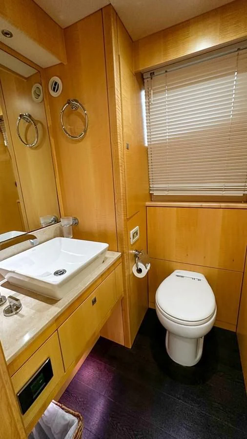 a bathroom with a toilet and sink aboard FUNSEEKER Yacht for Sale