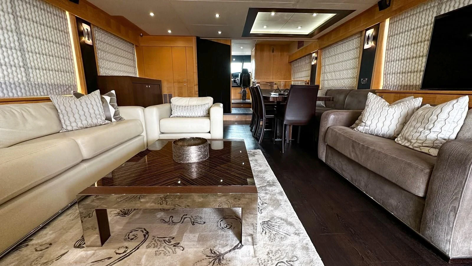 a living room with a couch and a coffee table aboard FUNSEEKER Yacht for Sale