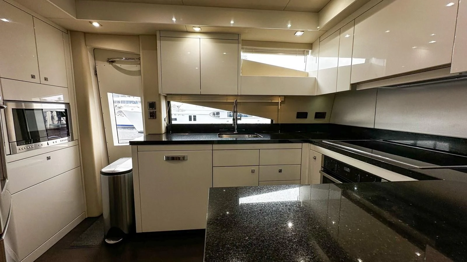 a kitchen with a black counter aboard FUNSEEKER Yacht for Sale