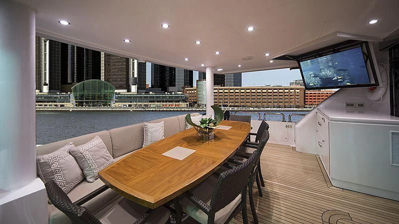 a large room with a table and chairs and a tv aboard CRYSTAL ANNE Yacht for Sale