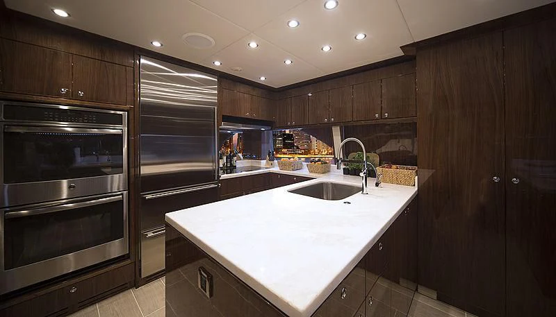 a kitchen with wooden cabinets aboard CRYSTAL ANNE Yacht for Sale